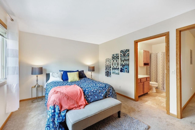 6911 Raymond Rd, Madison, WI 53711 - bedroom featuring light carpet, baseboards, and ensuite bathroom