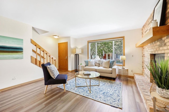 6911 Raymond Rd, Madison, WI 53711 - living room with stairway, wood finished floors, baseboards, and a brick fireplace
