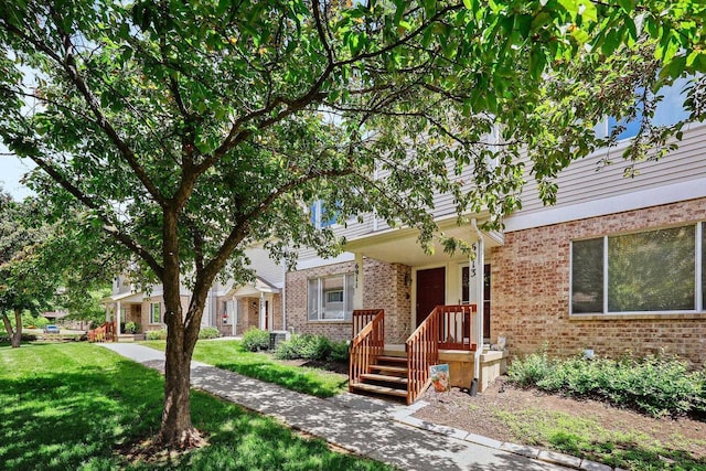 6911 Raymond Rd, Madison, WI 53711 - view of front of property with brick siding and a front lawn