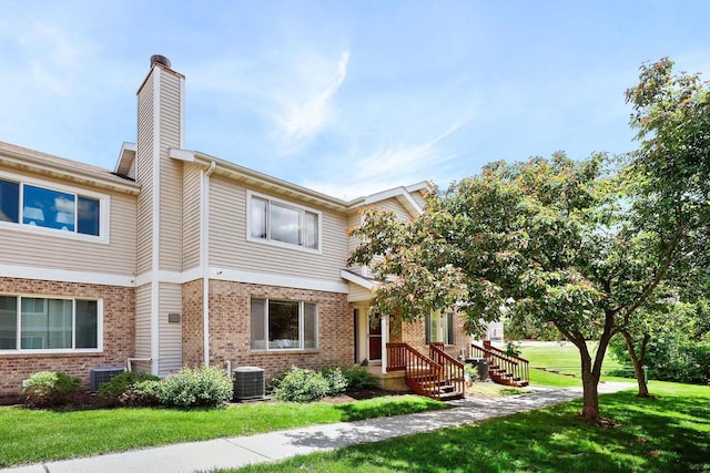 6911 Raymond Rd, Madison, WI 53711 - multi unit property featuring cooling unit, brick siding, and a front yard