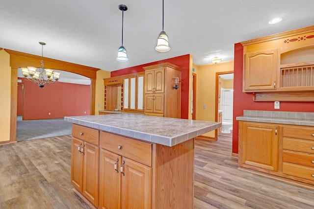 618 Little Fawn Dr, Nekoosa, WI 54457 - kitchen featuring a chandelier, light wood-type flooring, baseboards, and a textured ceiling