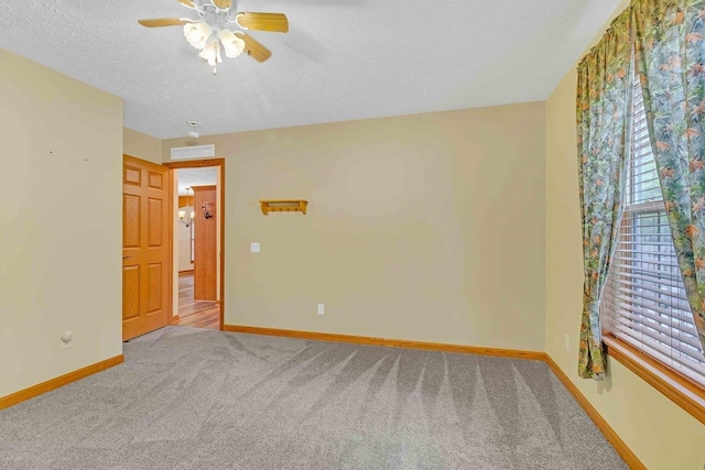 618 Little Fawn Dr, Nekoosa, WI 54457 - carpeted spare room with baseboards, ceiling fan, and a textured ceiling