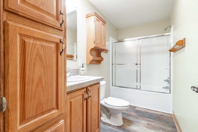 618 Little Fawn Dr, Nekoosa, WI 54457 - full bath with wood finished floors, toilet, vanity, and enclosed tub / shower combo