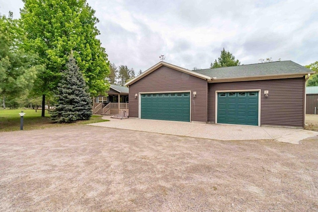 618 Little Fawn Dr, Nekoosa, WI 54457 - garage featuring driveway and covered porch
