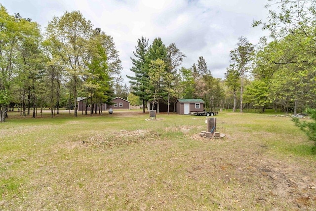 618 Little Fawn Dr, Nekoosa, WI 54457 - view of grassy yard with an outdoor structure and view of wooded area