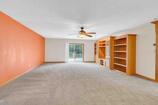 618 Little Fawn Dr, Nekoosa, WI 54457 - unfurnished living room with ceiling fan, carpet flooring, baseboards, and a textured ceiling