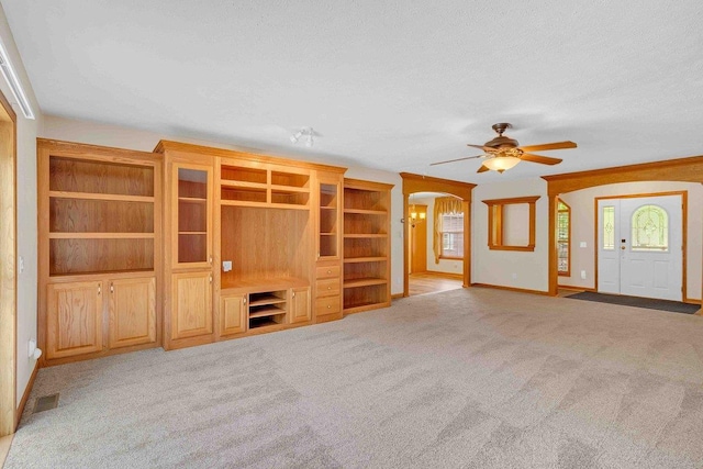 618 Little Fawn Dr, Nekoosa, WI 54457 - unfurnished living room featuring arched walkways, ceiling fan, carpet, and baseboards