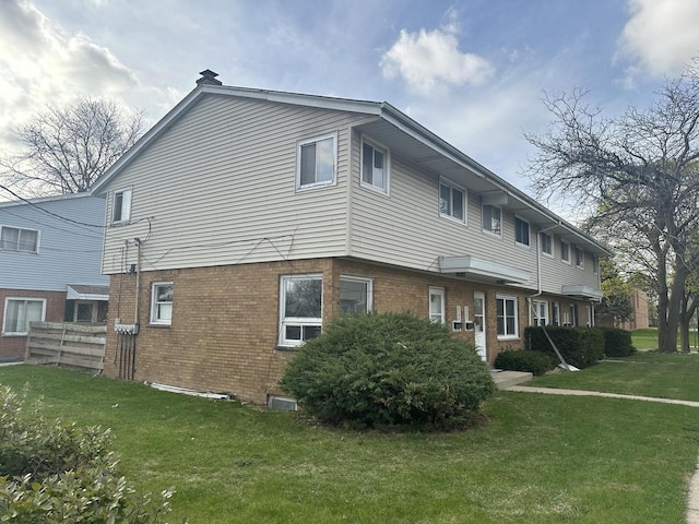 8594 W Villard Ave, Milwaukee, WI 53225 - view of property exterior featuring brick siding and a yard