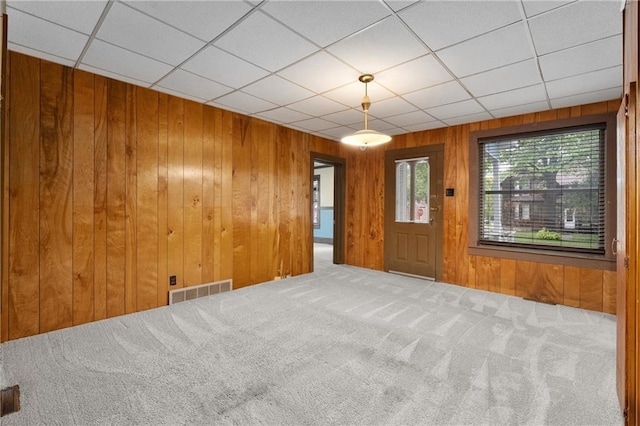 1020 E 10th St, Menomonie, WI 54751 - carpeted foyer entrance with wooden walls and a drop ceiling