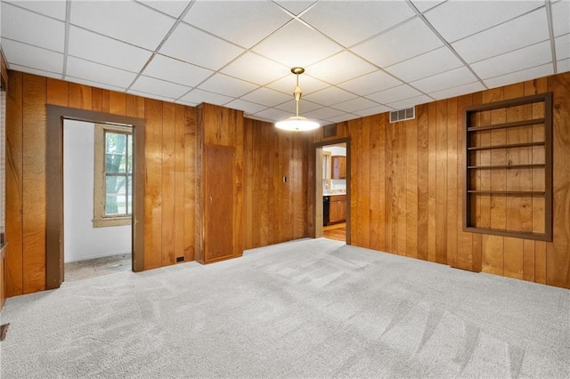 1020 E 10th St, Menomonie, WI 54751 - carpeted spare room with wooden walls, built in features, and a drop ceiling