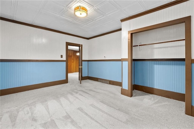 1020 E 10th St, Menomonie, WI 54751 - unfurnished bedroom featuring ornamental molding, carpet, baseboards, and an ornate ceiling