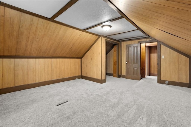 1020 E 10th St, Menomonie, WI 54751 - bonus room featuring carpet flooring, lofted ceiling, and wood walls