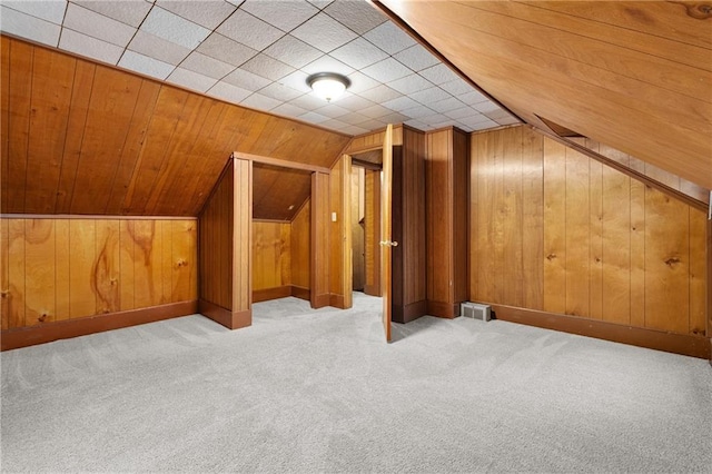 1020 E 10th St, Menomonie, WI 54751 - additional living space with carpet floors, wooden walls, and vaulted ceiling