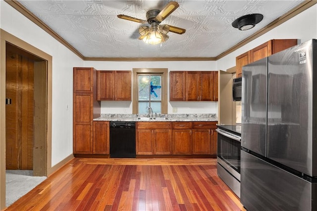 1020 E 10th St, Menomonie, WI 54751 - kitchen with black appliances, an ornate ceiling, a sink, wood-type flooring, and ceiling fan