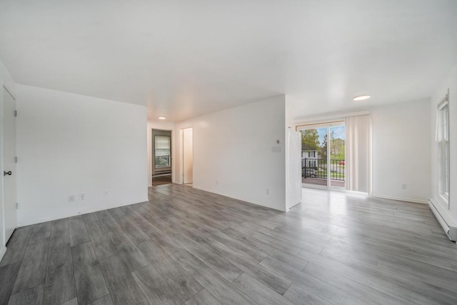 3933 Country Pl Unit D, Sheboygan, WI 53081 - unfurnished room with wood finished floors, a baseboard radiator, and recessed lighting