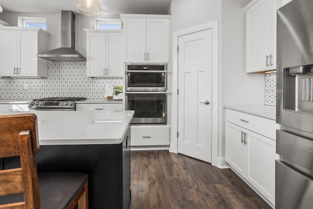 W239N7521 High Ridge Dr, Sussex, WI 53089 - kitchen featuring wall chimney exhaust hood, stainless steel appliances, dark wood-type flooring, light countertops, and tasteful backsplash
