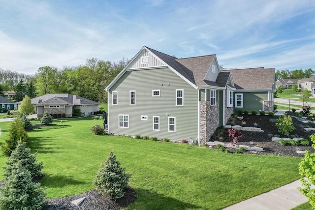 W239N7521 High Ridge Dr, Sussex, WI 53089 - view of side of property with a yard, stone siding, and roof with shingles