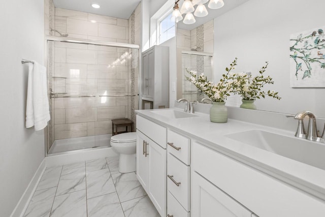 W239N7521 High Ridge Dr, Sussex, WI 53089 - bathroom with marble finish flooring, a shower stall, toilet, double vanity, and baseboards