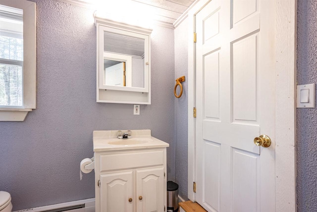 134 Glen View Dr Unit 44, Wisconsin Dells, WI 53965 - bathroom with vanity, a baseboard radiator, a textured wall, and toilet
