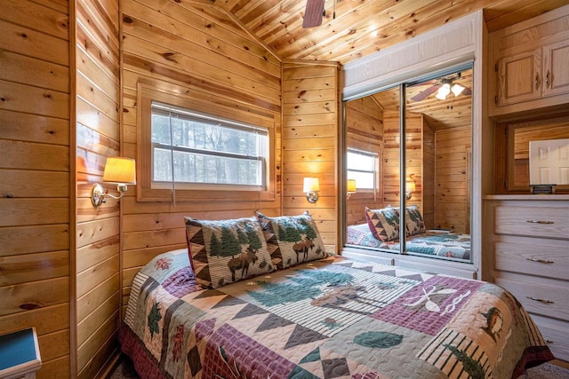 134 Glen View Dr Unit 44, Wisconsin Dells, WI 53965 - bedroom featuring vaulted ceiling, wooden walls, wood ceiling, a closet, and ceiling fan