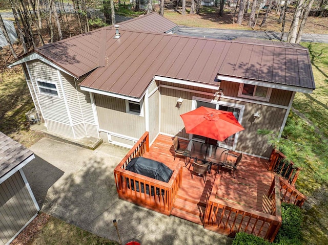 134 Glen View Dr Unit 44, Wisconsin Dells, WI 53965 - rear view of house with a deck, outdoor dining area, and metal roof