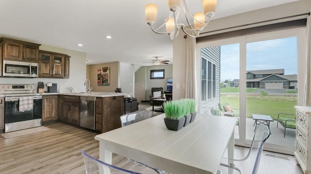 20170 63rd Ave, Chippewa Falls, WI 54729 - kitchen featuring appliances with stainless steel finishes, healthy amount of natural light, a peninsula, light wood finished floors, and recessed lighting