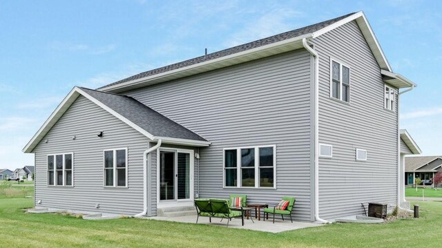 20170 63rd Ave, Chippewa Falls, WI 54729 - rear view of house with a lawn and a patio