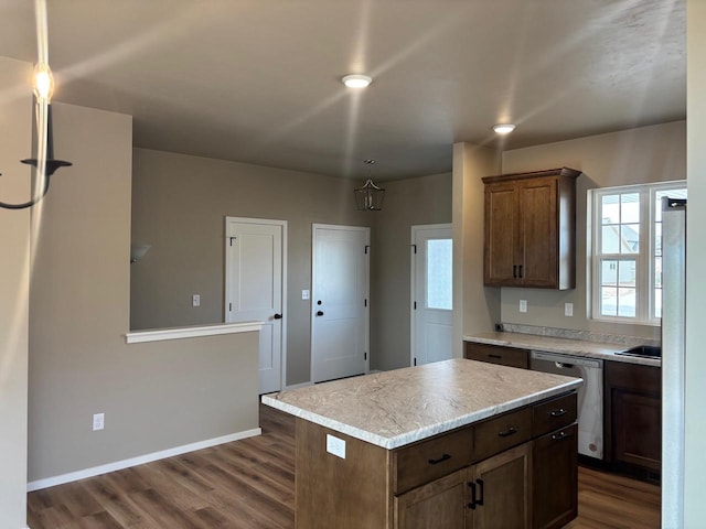 1236 Northwood Dr, Seymour, WI 54165 - kitchen with dishwasher, dark wood-style flooring, light countertops, baseboards, and a center island