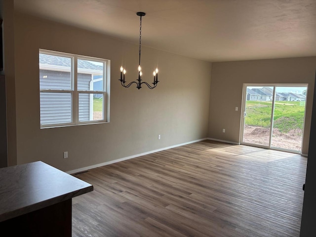 1236 Northwood Dr, Seymour, WI 54165 - unfurnished dining area featuring a chandelier, baseboards, and wood finished floors