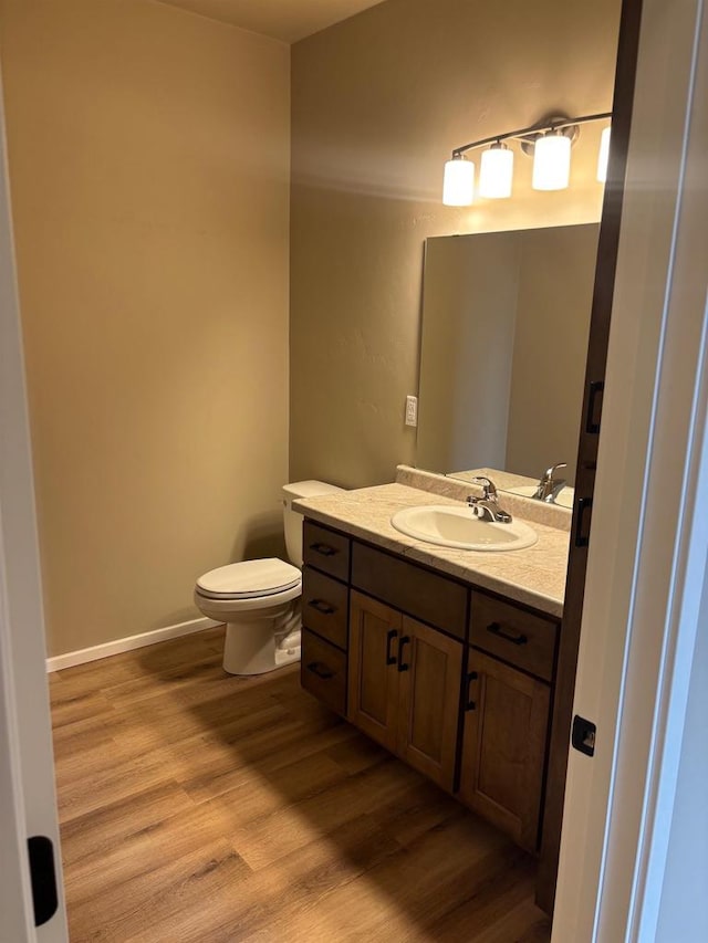 1236 Northwood Dr, Seymour, WI 54165 - bathroom with wood finished floors, vanity, and toilet