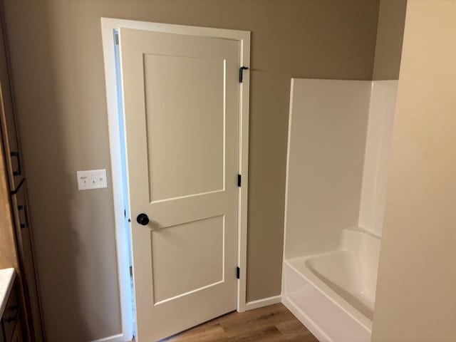 1236 Northwood Dr, Seymour, WI 54165 - bathroom with vanity, wood finished floors, a tub, a shower, and baseboards