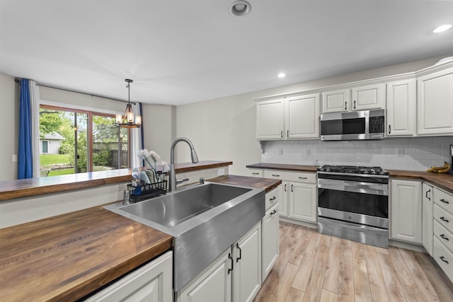 5806 E Open Mdw, Mcfarland, WI 53558 - kitchen with butcher block counters, appliances with stainless steel finishes, light wood-style floors, white cabinetry, and recessed lighting