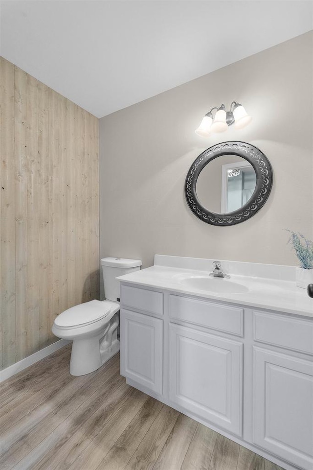 5806 E Open Mdw, Mcfarland, WI 53558 - bathroom featuring wood finished floors, wood walls, vanity, and toilet