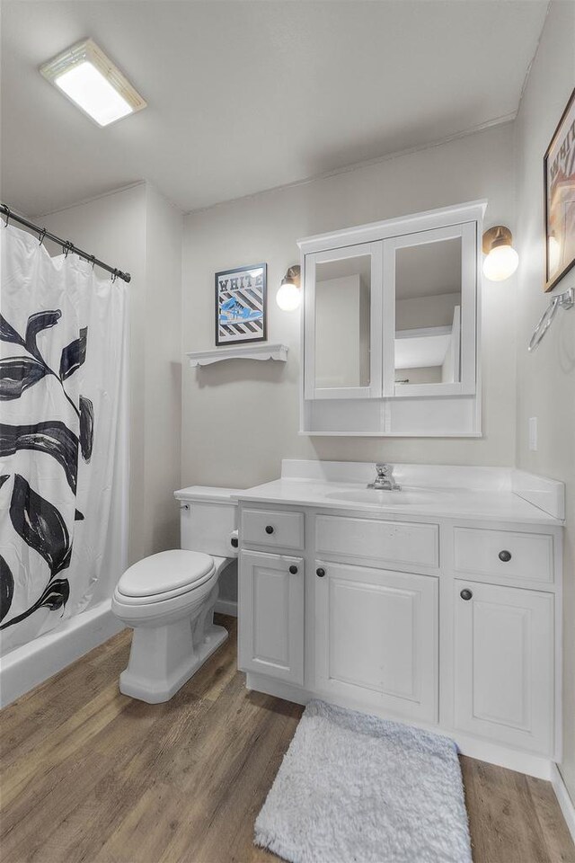 5806 E Open Mdw, Mcfarland, WI 53558 - bathroom with wood finished floors, vanity, toilet, and a shower with shower curtain