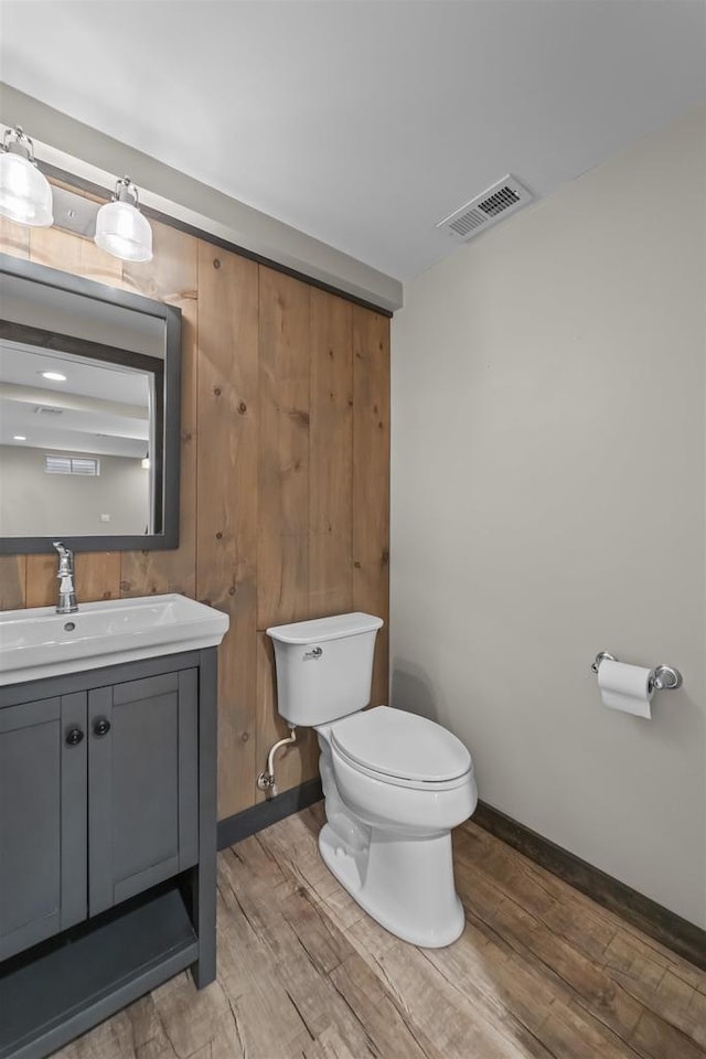 5806 E Open Mdw, Mcfarland, WI 53558 - half bath featuring toilet, wood finished floors, vanity, and baseboards