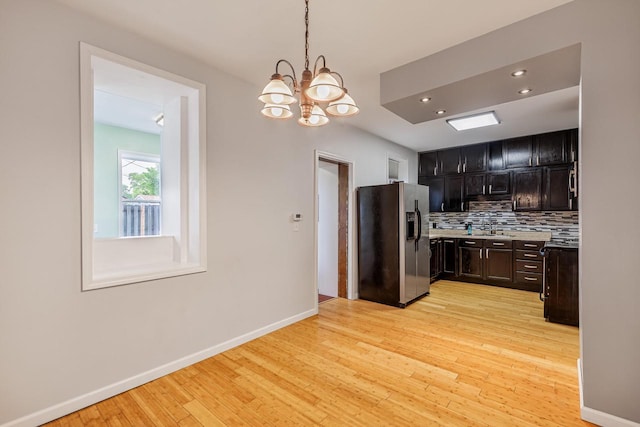 415 Ferry St, La Crosse, WI 54601 - kitchen featuring stainless steel fridge, light wood finished floors, decorative backsplash, baseboards, and recessed lighting