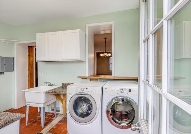 415 Ferry St, La Crosse, WI 54601 - laundry area with electric panel, independent washer and dryer, tile patterned flooring, and a chandelier