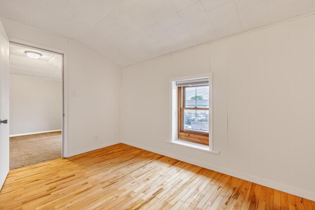 415 Ferry St, La Crosse, WI 54601 - empty room featuring light wood-style flooring, baseboards, and vaulted ceiling