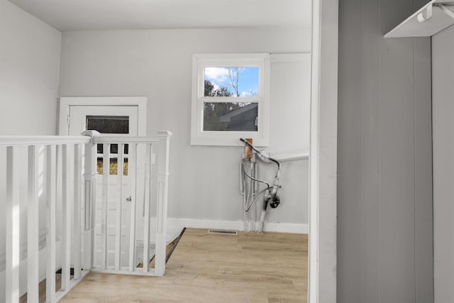 924 N Stevens St, Rhinelander, WI 54501 - hallway with wood finished floors, baseboards, and an upstairs landing