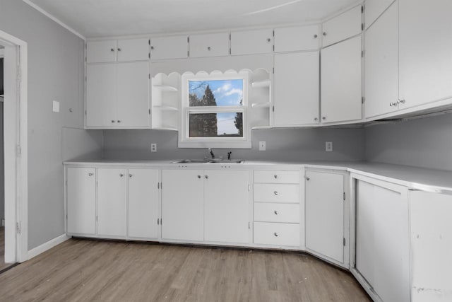 924 N Stevens St, Rhinelander, WI 54501 - kitchen with open shelves, a sink, light wood-type flooring, and light countertops