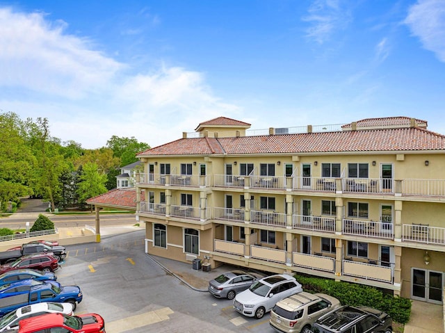 335 Wrigley Dr Unit 411, Lake Geneva, WI 53147 - view of apartment building / complex featuring uncovered parking