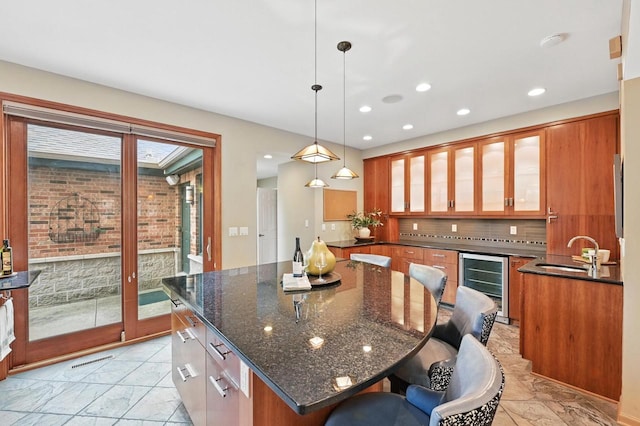 1420 N Astor St, Milwaukee, WI 53202 - kitchen featuring wine cooler, brown cabinetry, a sink, and recessed lighting