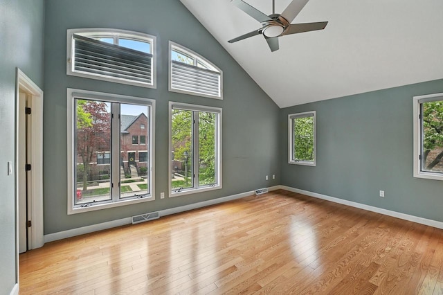 1420 N Astor St, Milwaukee, WI 53202 - empty room with high vaulted ceiling, wood finished floors, a ceiling fan, and baseboards