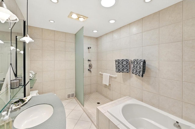 1420 N Astor St, Milwaukee, WI 53202 - bathroom with tile walls, a tile shower, a bath, tile patterned flooring, and recessed lighting