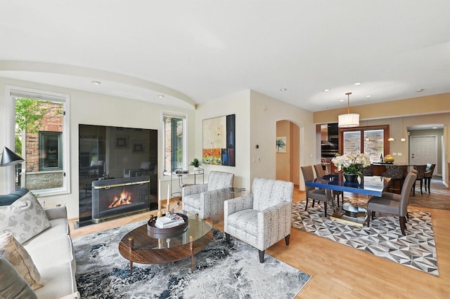 1420 N Astor St, Milwaukee, WI 53202 - living room with arched walkways, wood finished floors, a glass covered fireplace, and recessed lighting