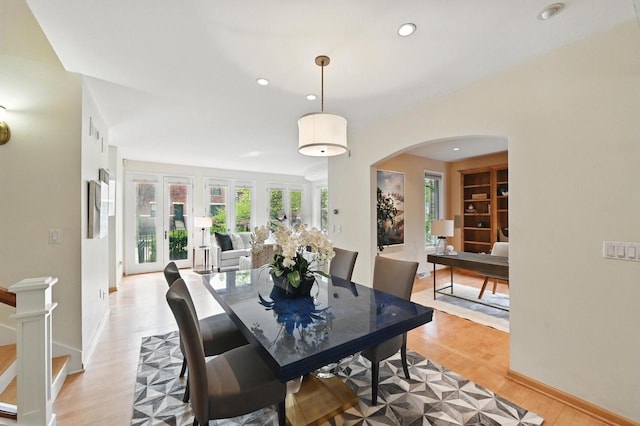 1420 N Astor St, Milwaukee, WI 53202 - dining room with arched walkways, healthy amount of natural light, light wood finished floors, recessed lighting, and baseboards