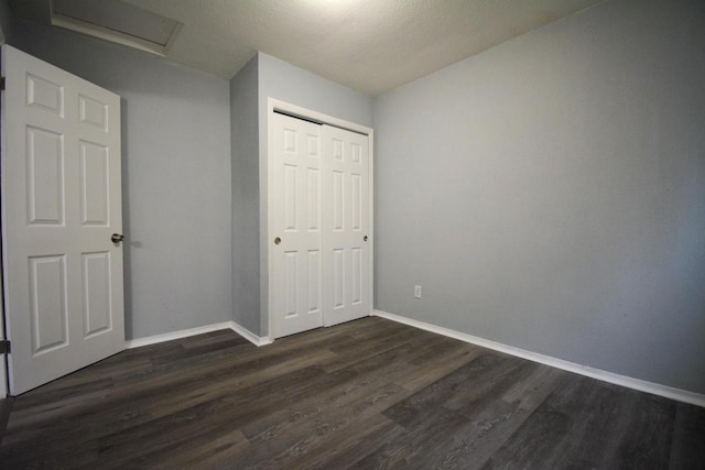 4646 N 51st Blvd, Milwaukee, WI 53218 - unfurnished bedroom with dark wood-style floors, attic access, baseboards, and a closet