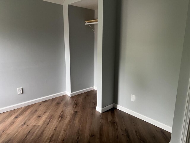 667 S Ira St, Richland Center, WI 53581 - unfurnished bedroom featuring baseboards, dark wood-type flooring, and a closet