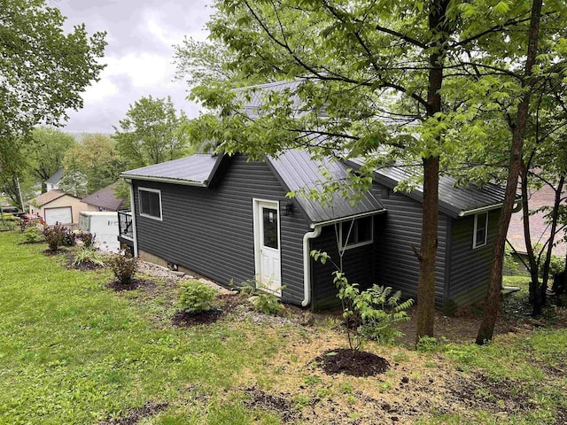 667 S Ira St, Richland Center, WI 53581 - view of side of home with metal roof, a lawn, and a garage