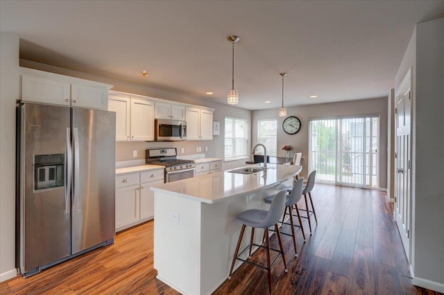 9327 Silicon Prairie Pkwy, Verona, WI 53593 - kitchen with appliances with stainless steel finishes, a sink, white cabinetry, a center island with sink, and recessed lighting